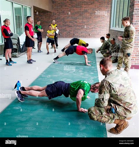 U.S. Soldiers with the Utah National Guard perform push-ups as part of ...
