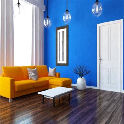 Mid-Century Modern Living Room Design With Blue Sofa and Orange Pouffe