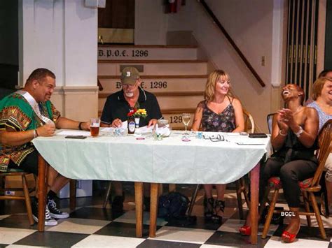 Men participate in a pageant dressed as women