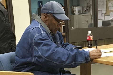 O.J. Simpson signs documents at the Lovelock Correctional Center ...