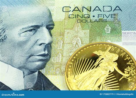 A Canadian Five Dollar Bill with a Gold Coin in Macro Stock Image ...