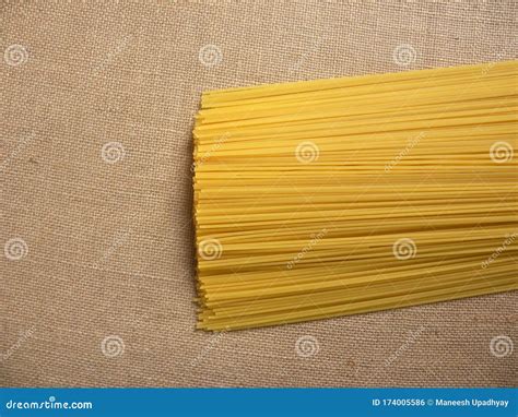 Yellow Raw Thin Spaghetti Noodles Stock Photo - Image of culture, bunch ...