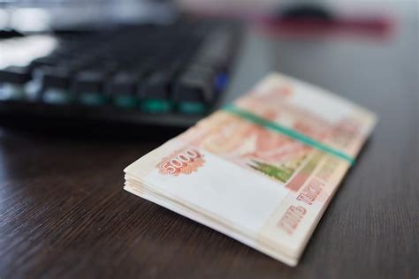 Premium Photo | Russian money above the black computer keyboard remote ...