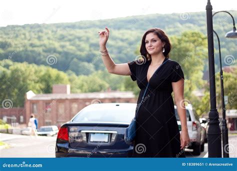 Woman Hailing a Taxi Cab stock image. Image of female - 18389651