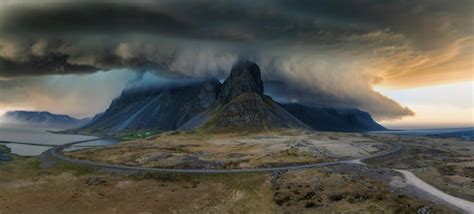 Aerial view of storm clouds over rugged mountain range in iceland ...