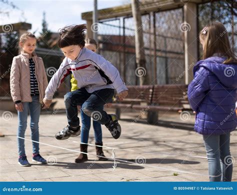 Active Children`s Games. Boy Jumps Over the Rope Stock Image - Image of ...
