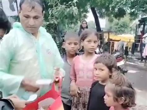 In the pouring rain, a government official along with a family ...
