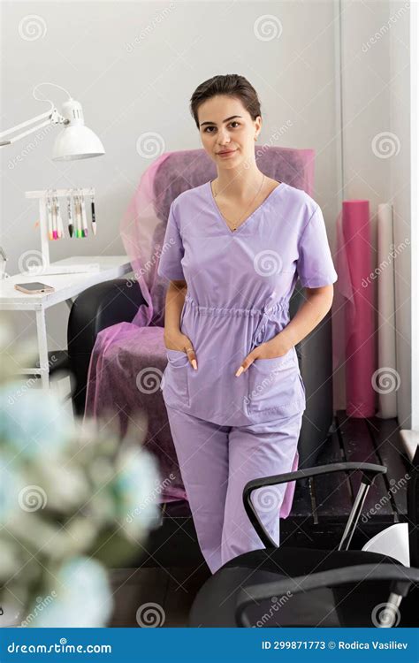 Professional Manicure Master in Purple Uniform in a Beauty Salon ...