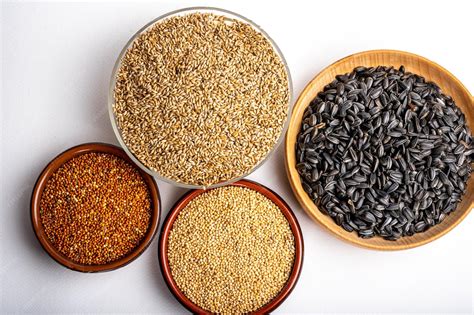 Premium Photo | Dried grains bird food red millet grain yellow millet grain black sunflower ...