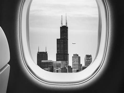 Download wallpaper 1400x1050 porthole, bw, airplane window, buildings ...