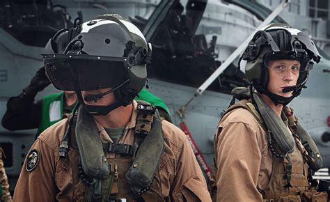 AH-1Z pilots 1st Lt. Michael Tetrealt and Capt. Travis Patterson wearing helmet mounted displays ...