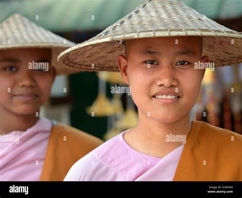 Two young Burmese Buddhist nuns with Asian conical hats Stock Photo - Alamy