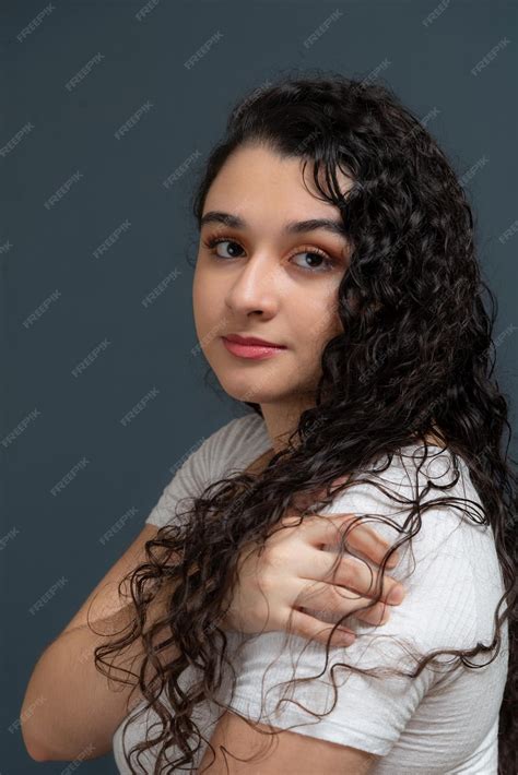 Premium Photo | Cheerful beautiful young woman with hand on shoulder ...