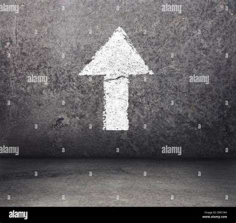 Concrete room with arrow on the wall pointing upward Stock Photo - Alamy
