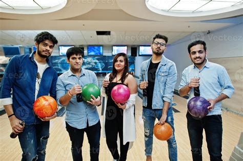 Group of five south asian peoples having rest and fun at bowling club ...
