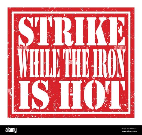 STRIKE WHILE THE IRON IS HOT, words written on red stamp sign Stock ...