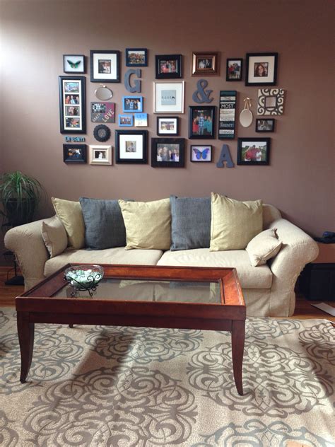 Picture wall above the couch with a mixture of different color, size and shape frames, canvases ...