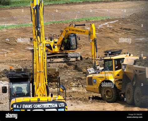 Heavy earth moving machinery preparing rural land for housing ...