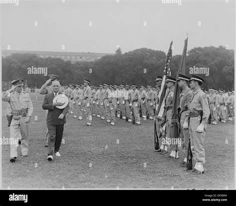 Photograph of President Truman and military officers saluting as they ...