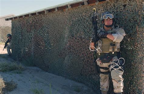 US Navy (USN) SEAL Team Members armed with a 5.56mm M4 carbine equipped ...