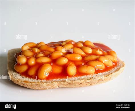 Baked beans on a slice of toast on a white background Stock Photo - Alamy