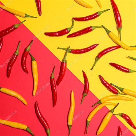 Red and yellow hot chili peppers on red and yellow background - Stock ...