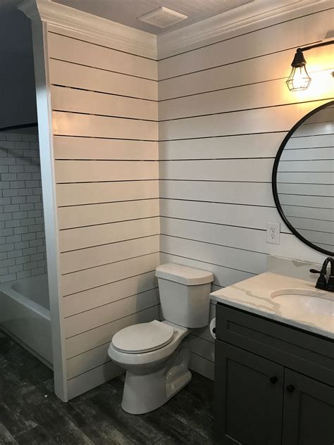 Shiplap walls throughout the bathroom accenting the subway tile used ...