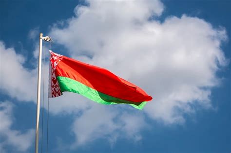 Belarusian flag against blue sky | Premium Photo