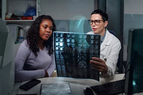 Image of a doctor and a patient reviewing a scan.