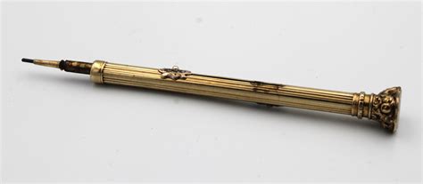Lot - A Victorian yellow metal propelling pencil / pen combination