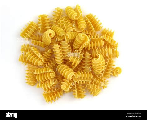Pasta made of durum wheat top view. Spiral pasta on a white background ...