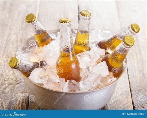Cold Bottles of Beer in Bucket with Ice Stock Photo - Image of beverage ...
