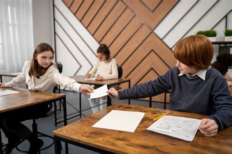 Side view kid cheating at school test | Free Photo