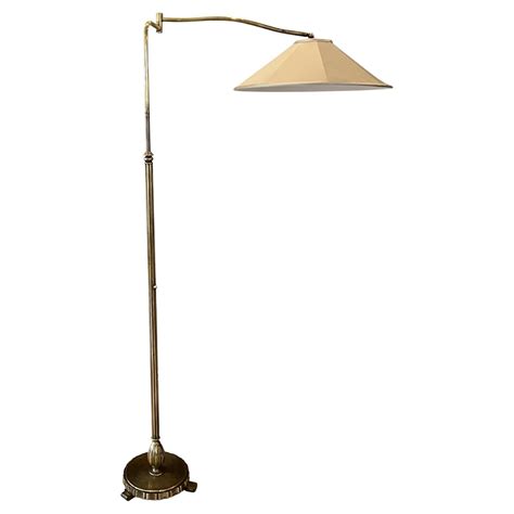 A pair of black wrought iron swing arm floor lamps at 1stDibs