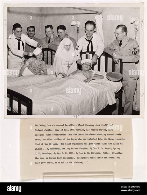 Photograph of Coast Guardsmen Standing Around the Beds of Two Boys with ...