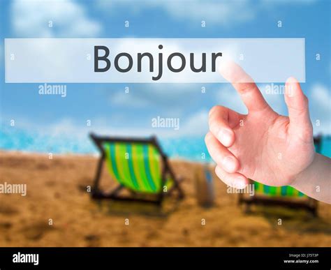 Bonjour (Good Morning in French) - Hand pressing a button on blurred ...