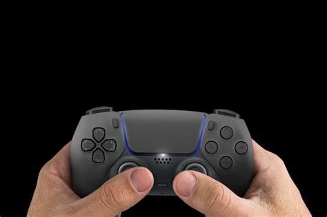 Male hand holding a next generation black game controller isolated on ...