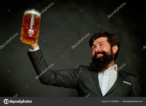 Beer in the US. Portrait of handsome young man tasting a draft beer ...
