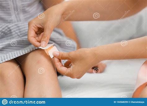 Woman Applying Plaster On Girl`s Knee Stock Image - Image of childhood, bandage: 154568299