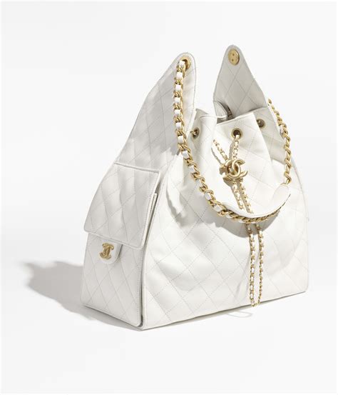 Chanel 25 medium handbag, Grained calfskin & gold-tone metal, white ...