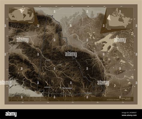 Yukon, territory of Canada. Elevation map colored in sepia tones with lakes and rivers ...
