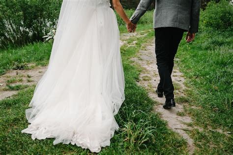 View of the bottom couple newlyweds bride and groom walking back on a ...