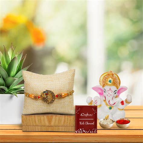 Designer Peacock Rakhi for Brother with Lord Ganesha Idol and Roli Cha ...