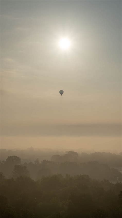 Download wallpaper 938x1668 hot air balloon, sky, sun, light, forest ...