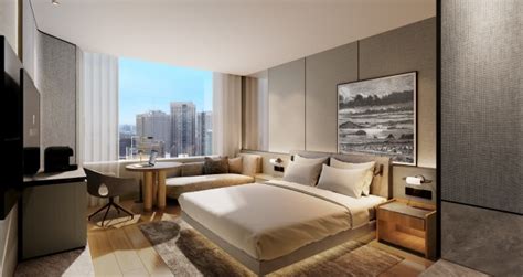 JW Marriott bed in hotel room with logo on an accent pillow