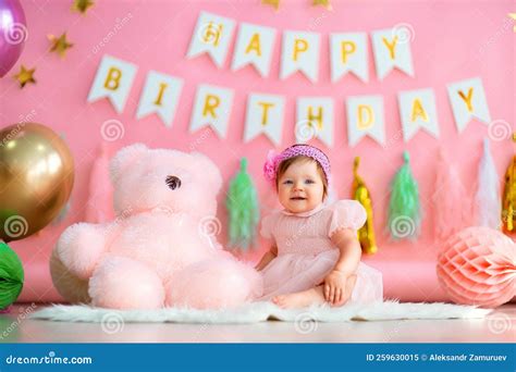 Happy Baby Girl Sits Near Paper Balls with Teddy in Holiday Dress on ...