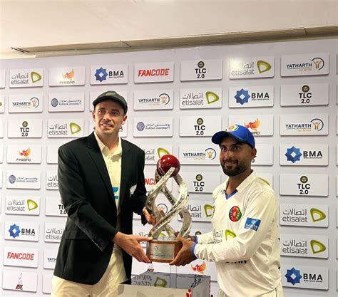 Tim Southee and Hashmatullah Shahidi have a chat at the trophy ...