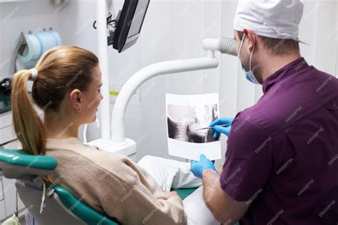 Premium Photo | Dentist explain to patient on xray panoramic ...