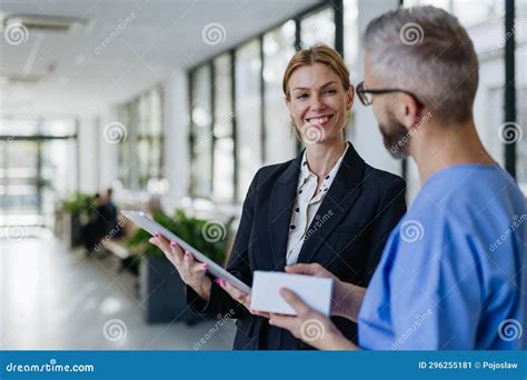 Pharmaceutical Sales Representative Talking with Doctor in Medical Building. Ambitious Female ...
