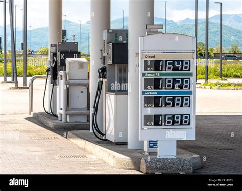 Display with fuel prices at fuel pump with filling nozzles in Italian ...